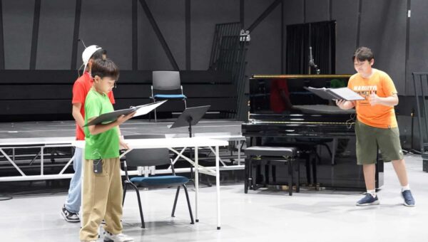 BSB06845 BASIS International School Bangkok students rehearsing from scores beside a piano