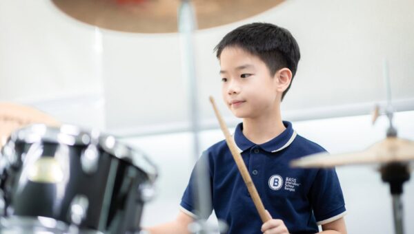 CR5_0541 A BASIS International School Bangkok student playing the drum kit