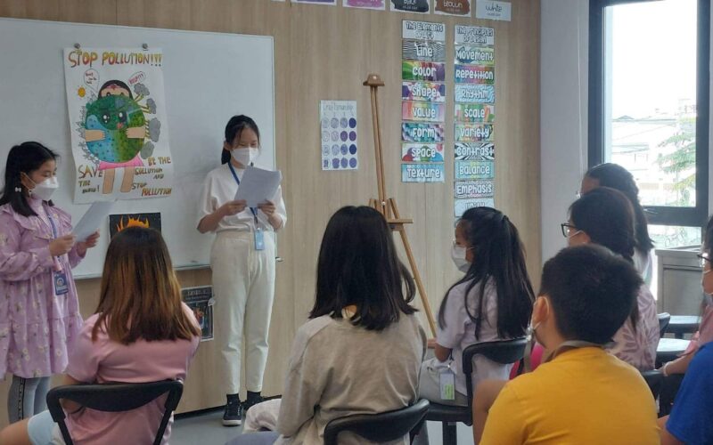 students 4-min BASIS International School Bangkok students presenting artwork on display in class